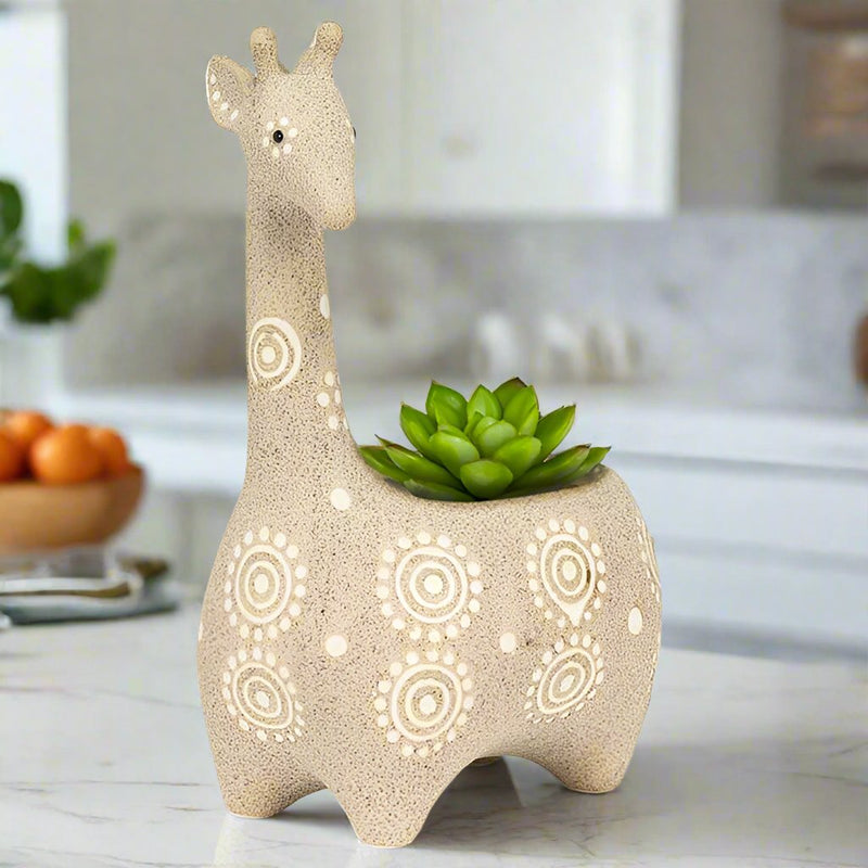 ivory giraffe shaped planter with succulent on a kitchen countertop