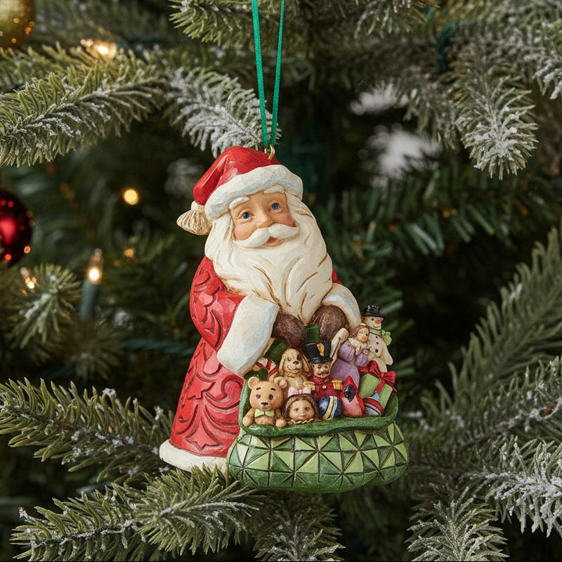 Jim Shore worldwide event ornament of Santa Claus with bag of toys hanging in a Christmas tree