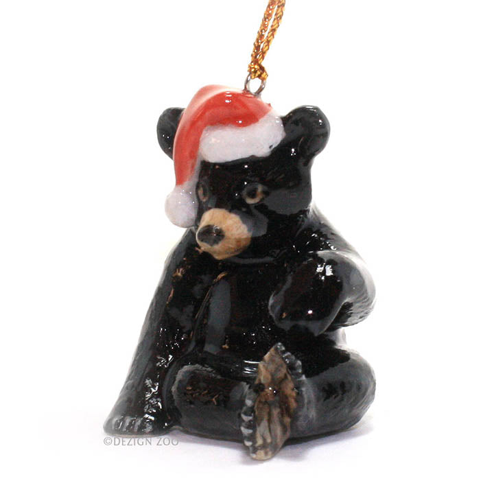 porcelain black bear with santa hat ornament facing forward left