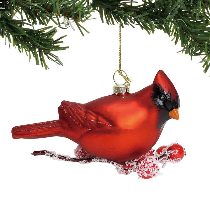 right side view of department 56 glass red cardinal on glittered faux snow covered berry branch ornament hanging from tree bough