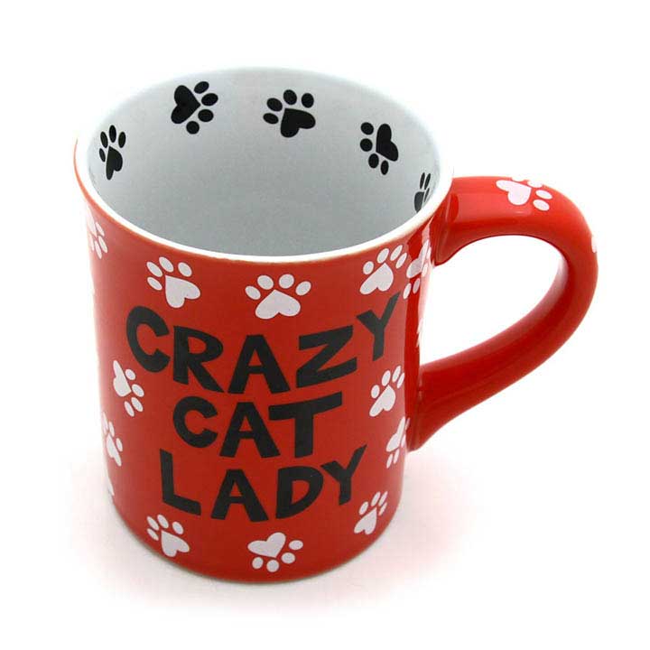 enesco, our name is mud, crazy cat lady mug - image showing red mug with white paw print design and black text, black paw print design around interior rim, handle to right