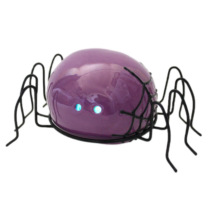 small purple spider halloween figurine with LED eyes and black metal legs front right view showing black web design on side