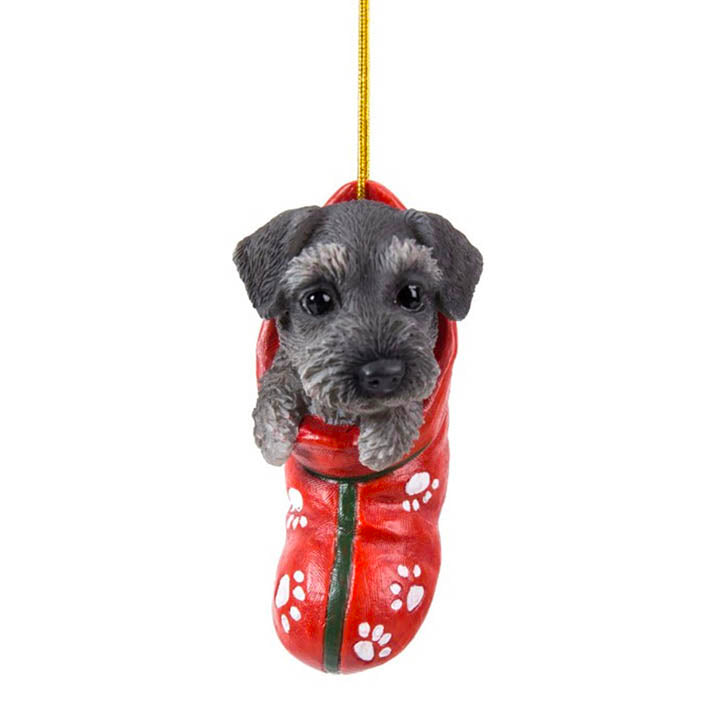 full view of schnauzer puppy in red stocking with white paw print designs christmas ornament hanging from gold colored cord