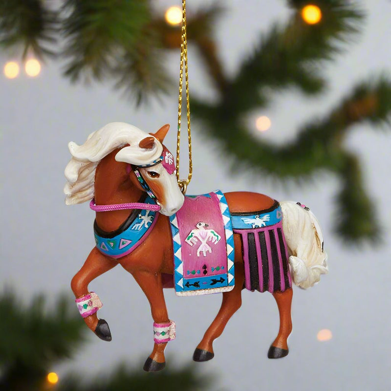 trail of painted ponies thunderbird ornament, palamino horse with blue and pink thunderbird art riding gear - left side view shown hanging from Christmas tree